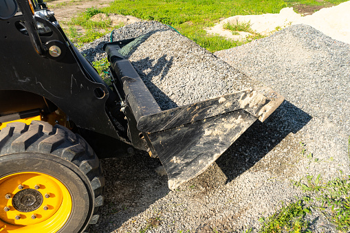 The loader picked up rubble in the bucket for construction work. Copy paste.