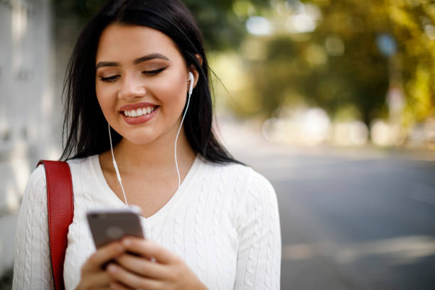 istock Young woman using mobile phone outdoors 1045082214