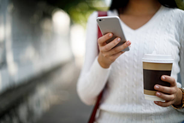 istock Woman using mobile phone on the street 1045082366