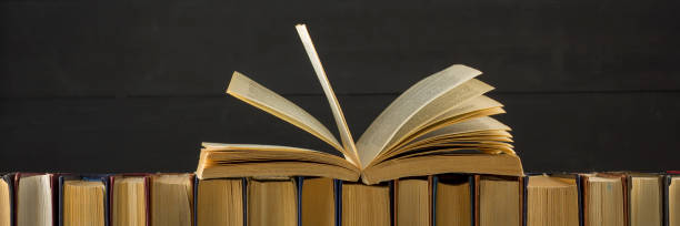 istock Open book, hardback books on wooden table. Back to school. Copy space 1045083004