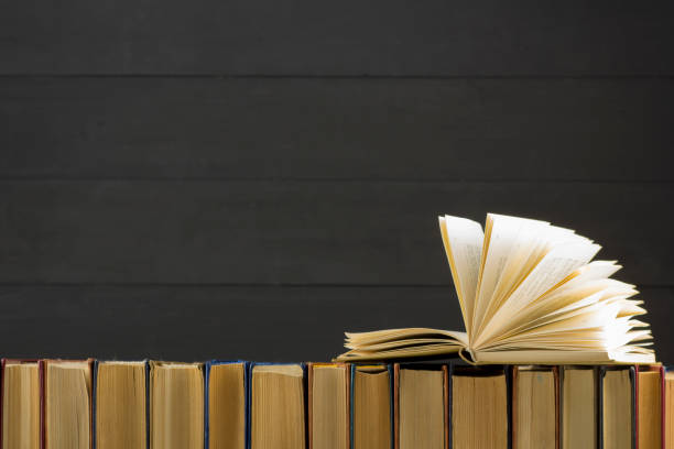 istock Open book, hardback books on wooden table. Back to school. Copy space 1045083028