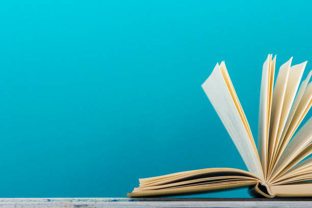 istock Open book, hardback books on wooden table. Back to school. Copy space 1045083030
