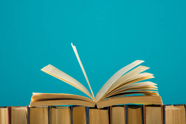 istock Open book, hardback books on wooden table. Back to school. Copy space 1045083032