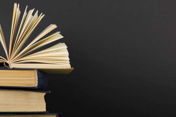 istock Open book, hardback books on wooden table. Back to school. Copy space 1045083034