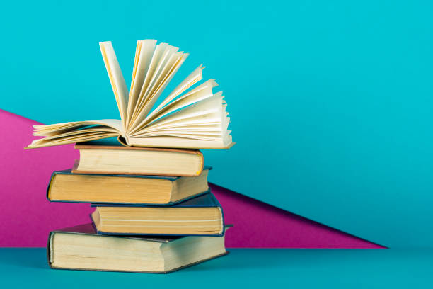 istock Open book, hardback books on wooden table. Back to school. Copy space 1045083046