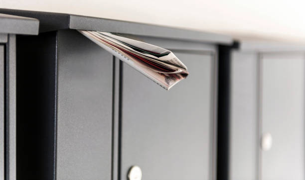 istock Gray metal mail boxes and folded newspaper in Germany 1045092178