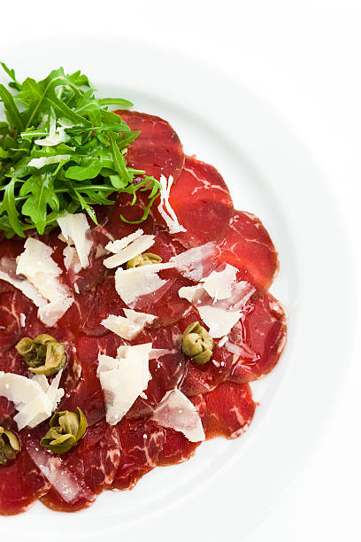 Beef Carpaccio Beef Carpaccio with shaved parmesan cheese and freshness salad carpaccio parmesan cheese beef raw stock pictures, royalty-free photos & images