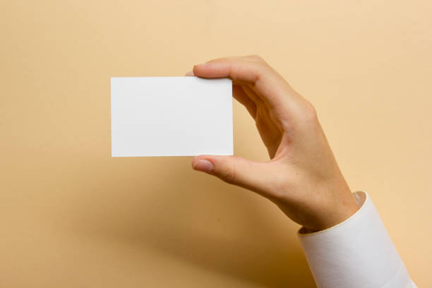 istock Hand holding business card blank on abstract background 1045103456