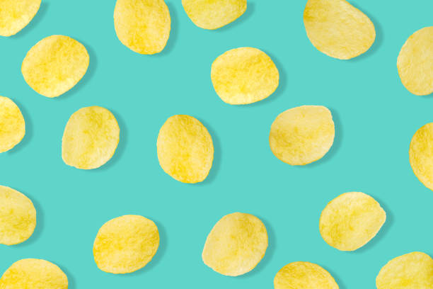 Potato chips pattern on pastel blue background top view flat lay Potato chips pattern on pastel blue background top view flat lay gold potato stock pictures, royalty-free photos & images