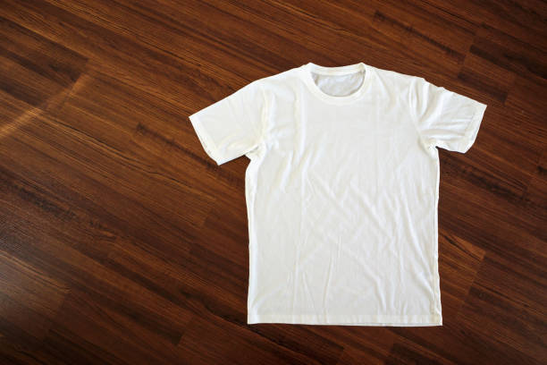 istock White t-shirt on wood background 1045106188