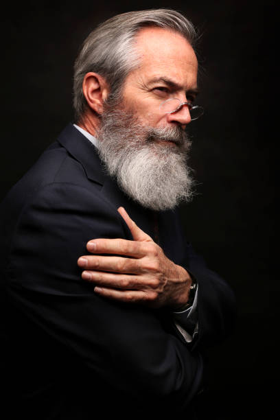 istock mature male model wearing suit with grey hairstyle and beard 1045111116