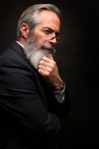 istock mature male model wearing suit with grey hairstyle and beard 1045111146