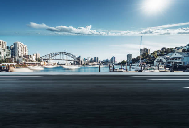 istock empty road by Sydney Harbor Bridge,Sydney 1045130278