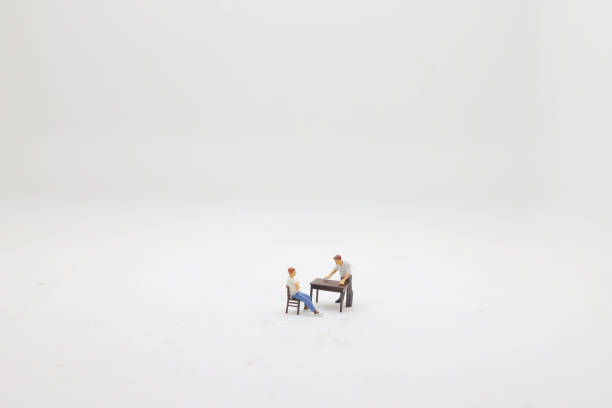 Businessman figurine sitting on digital tablet