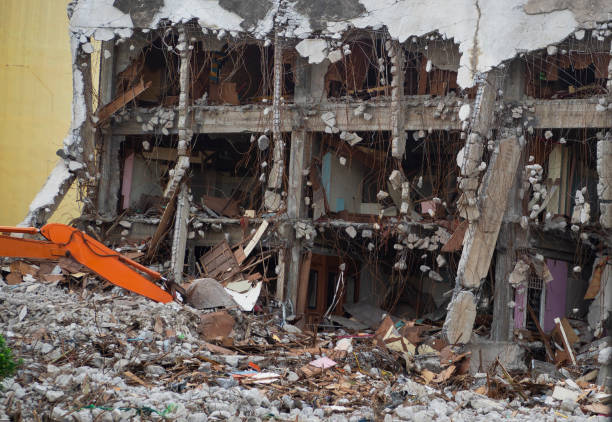 istock Destroyed building industrial. Building demolition by explosion. Abandoned concrete building with rubble and scrap. Earthquake ruin. Damaged or collapsed building from hurricane disaster. 1045143394
