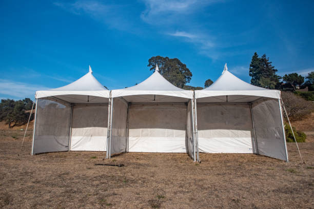 istock White tent in brown grass field under blue sky 1045152172