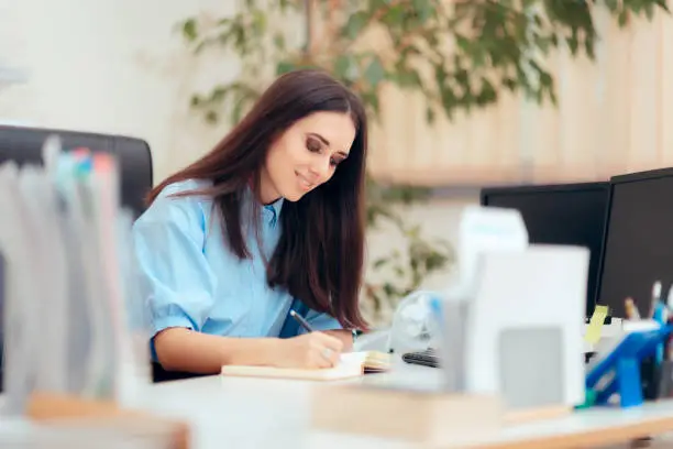 Photo of Female Desk Job Office Employee Working To Complete Tasks