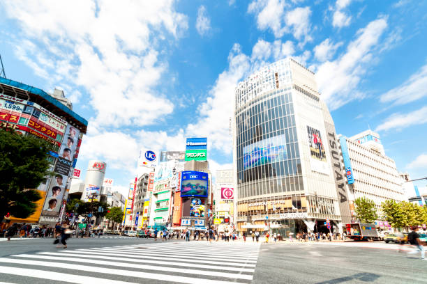 Shibuya Crossing Shibuya, Tokyo, Japan: Shibuya Crossing in sunny day tokyo crowds on the famous shibuya crossing japan stock pictures, royalty-free photos & images