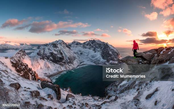 Man Mountaineer Standing On Rock Of Peak Mountain At Sunset Stock Photo - Download Image Now