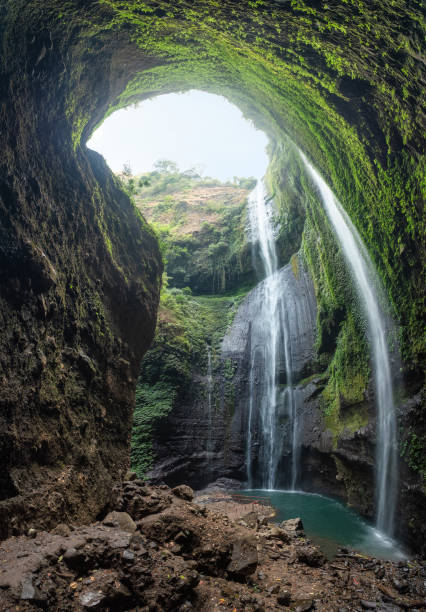 istock Majestic waterfall flowing on rocky cliff in tropical rainforest 1045220956