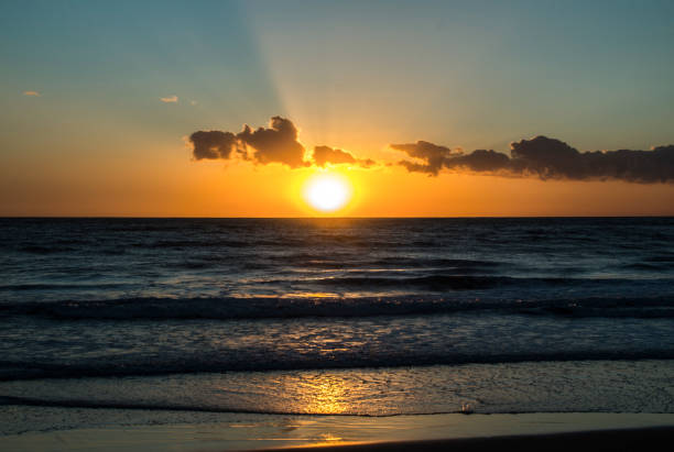 istock Waves and ocean mist at sunset 1045221528