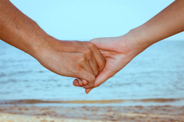 istock Close up of couple holding hands 1045221722