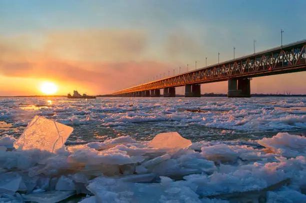 Photo of Ice drift on the Amur river.  Amur bridge, Trans siberian railway. Khabarovsk, far East, Russia.