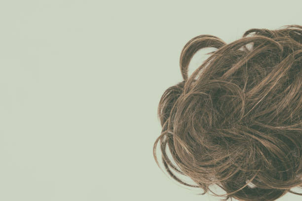 istock Curly brown hair isolated with vintage effect. Left copy space. 1045224638