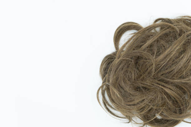 istock Curly brown hair isolated on white. Left copy space. 1045224654