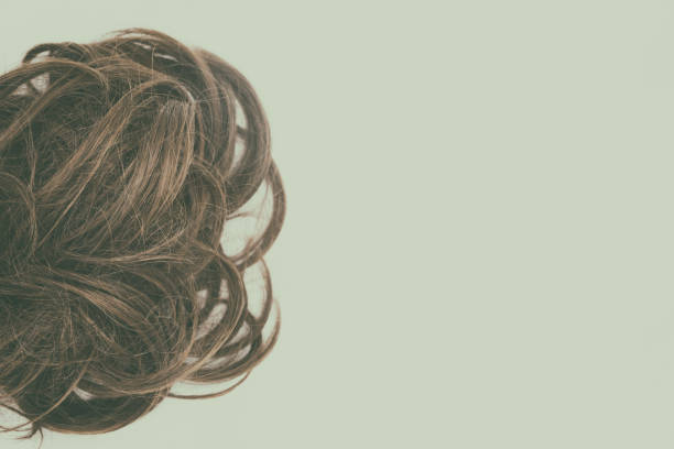 istock Curly brown hair isolated with vintage effect. Right copy space. 1045224808