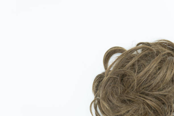 istock Curly brunette hair isolated on white background. Copy space. 1045224882