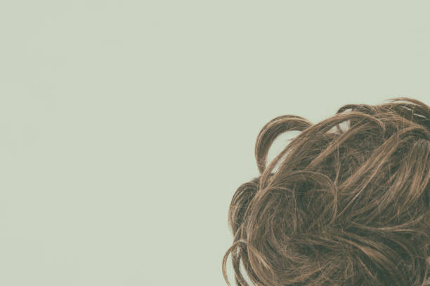 istock Curly brunette hair isolated with vintage effect. Copy space. 1045224936