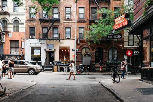 New York City, USA - June 22, 2018: Stores and business in MacDougal Street in Greenwich Village. It has been called the most colorful and magnetic venue for tourists in the Village