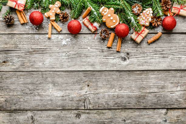 istock Fir tree with decorations - christmas gift boxes, snow and ornaments on wooden background 1045229188