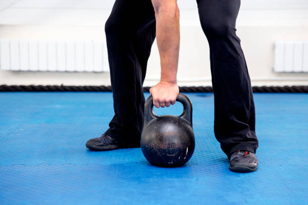 istock Young muscular man doing exercises in a gym 1045235234