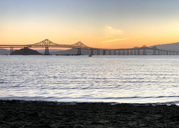 Richmond Bridge Richmond-San Rafael Bridge, Sunset. Shot from Pt. Molate Beach, Richmond, California, USA. san rafael california stock pictures, royalty-free photos & images