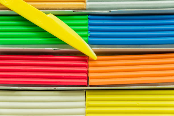 istock Set of multicolored plasticine bars for modeling in paper box. Top view, eduction and creativity concept 1045238726