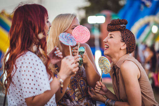 istock Happy friends with colorful lollipops 1045253320
