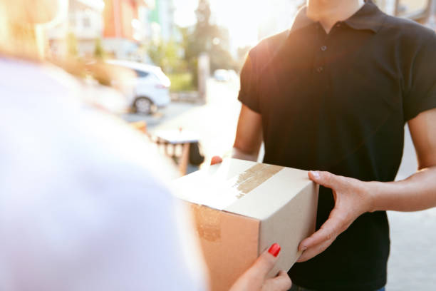 istock Courier Delivery Service. Closeup Hands Receiving Package 1045256906