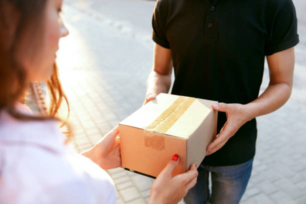 istock Courier Delivery Service. Closeup Hands Receiving Package 1045256990
