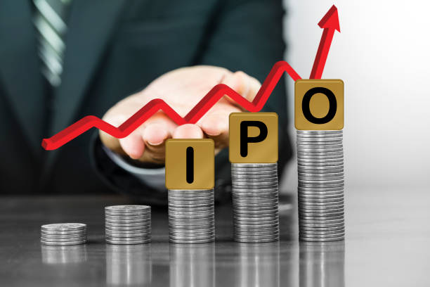 businessman hand holding red arrow up with the letters ipo on money coin stack arranged as a graph - capital letter fotos imagens e fotografias de stock