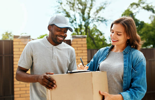 istock Courier Delivery Service. Man Delivering Package To Woman 1045263156
