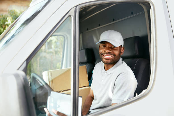 istock Courier Delivery. Black Man Driver Driving Delivery Car 1045263326