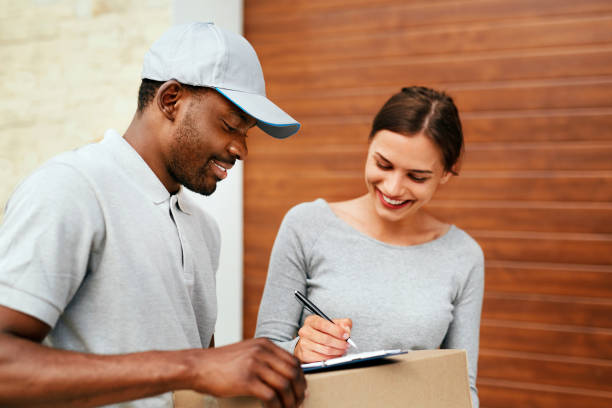 istock Courier Delivery Service. Man Delivering Package To Woman 1045263384
