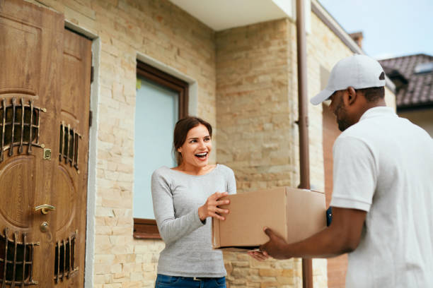 istock Home Delivery. Courier Delivering Package To Client 1045266130