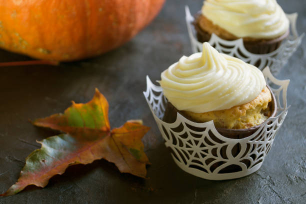 istock Homemade cupcakes with cream. on dark background. 1045269174