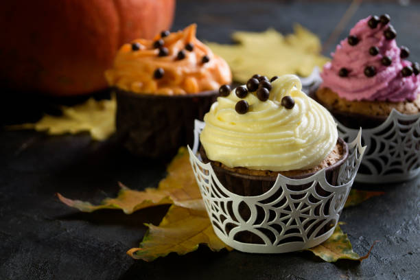 istock Homemade cupcakes with cream. on dark background. 1045269324