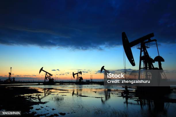 In The Evening The Outline Of The Oil Pump Stock Photo - Download Image Now - Crude Oil, Oil Industry, Gas