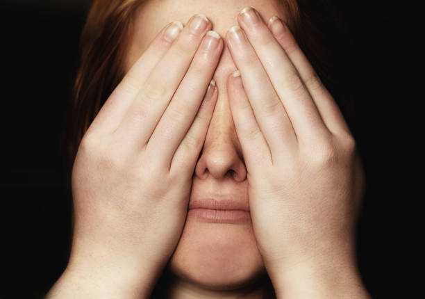 istock Miserable young woman covering face with hands 1045272812