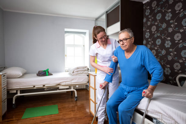 istock Helping to immobility at nursing home 1045273608